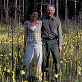 Stone County, author and wife, with flowering plants.