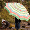 Phill shielding Beth from the rain, Western Australia.